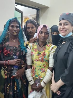 Female surgeon smiling with a group of local women at a surgical free medical camp.