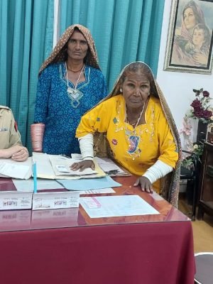Female doctor in uniform smiling with satisfied patients at her clinic desk during a consultation.