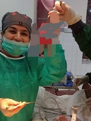 Dr. Hina Urooj and her surgical team celebrating a successful medical procedure in the operation theater.