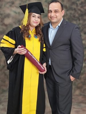 Female doctor in a graduation gown holding an FCPS degree from the College of Physicians and Surgeons Pakistan.